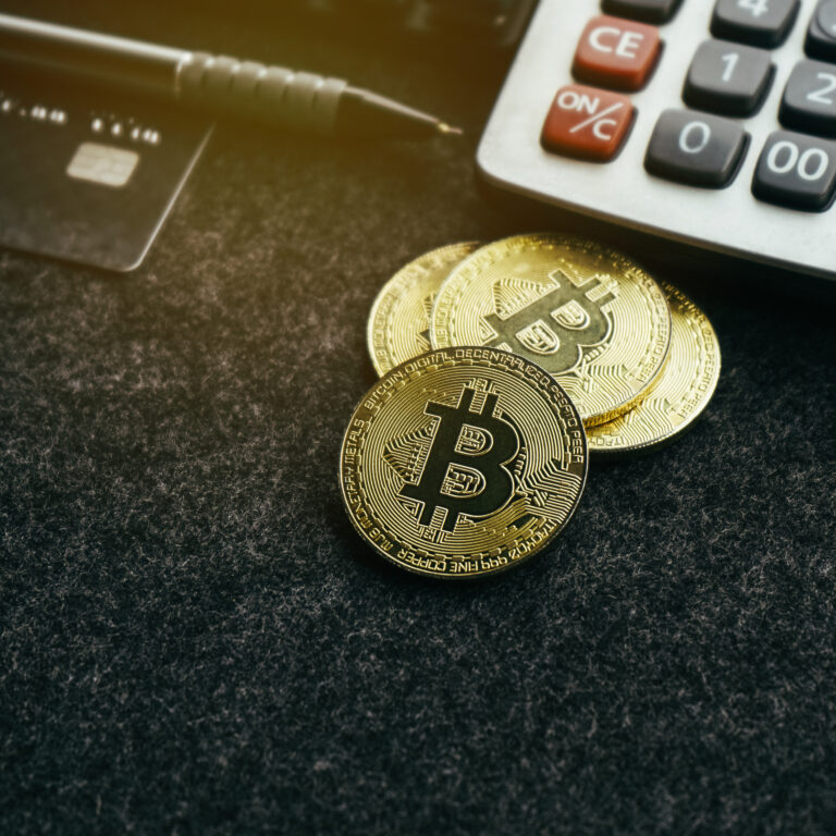 gold-bitcoin-coin-on-office-desk-with-calculator-2024-12-07-04-50-33-utc