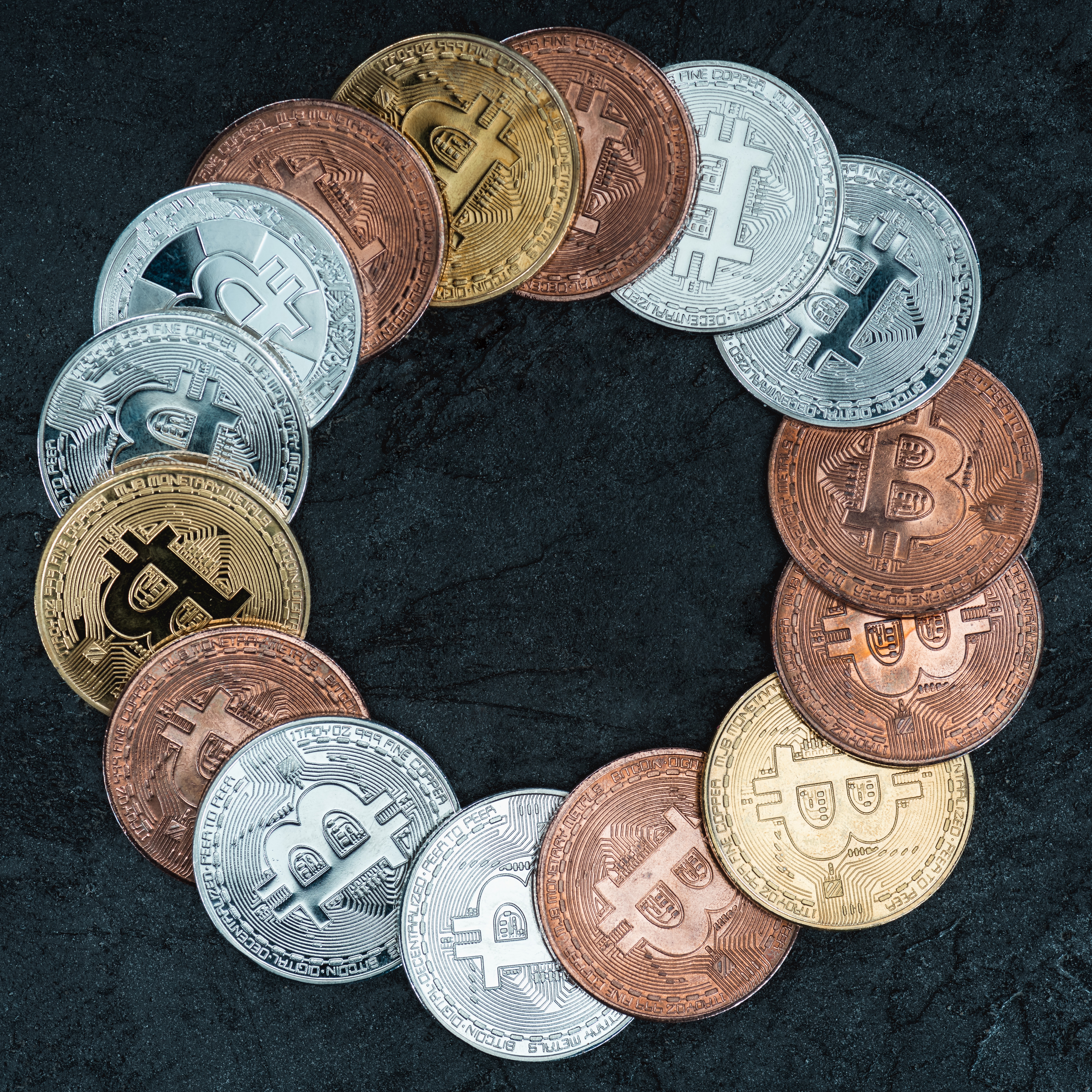 top view of arranged bitcoins in circle on marble tabletop